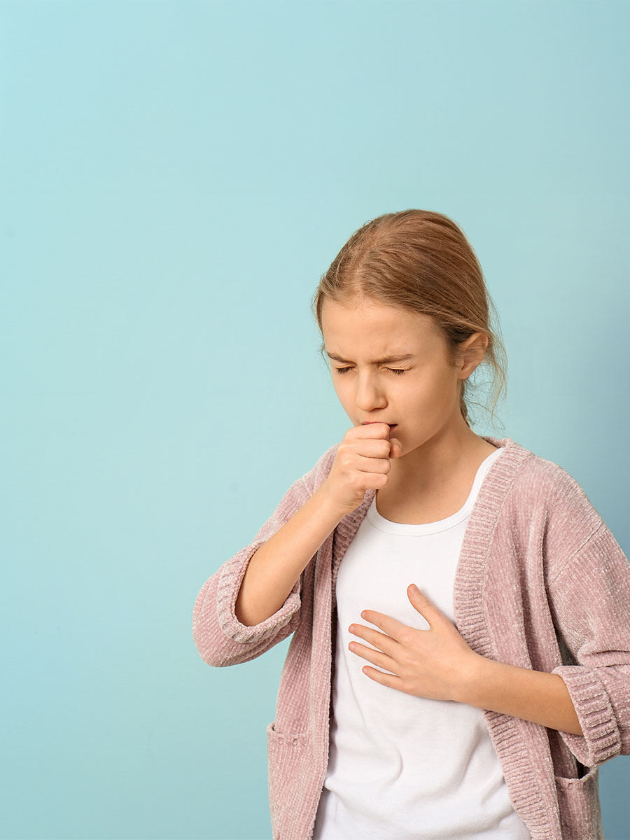 Young girl coughing severely, showing symptoms of whooping cough.