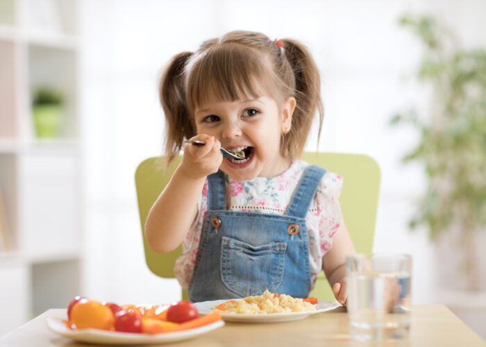 kid child girl eating healthy food at home