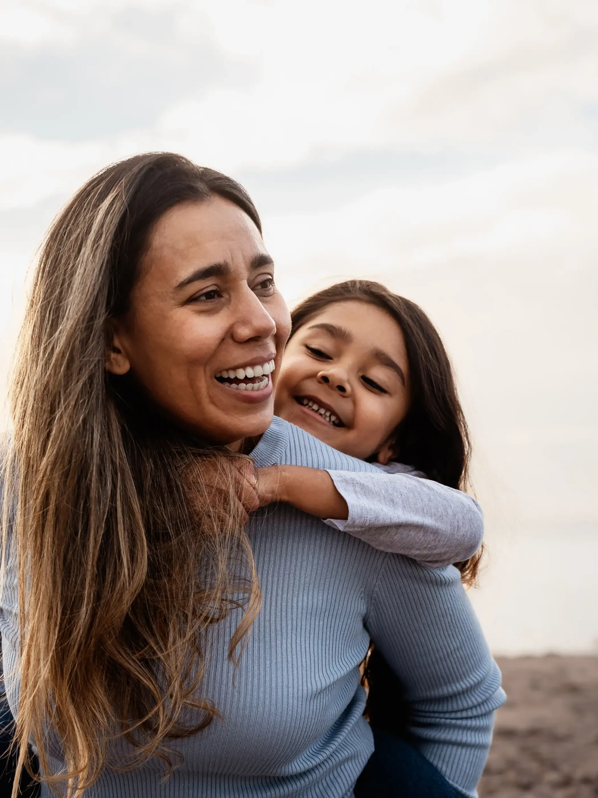 mom and daughter smiling