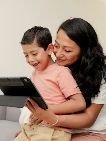 Son and mom looking at ipad