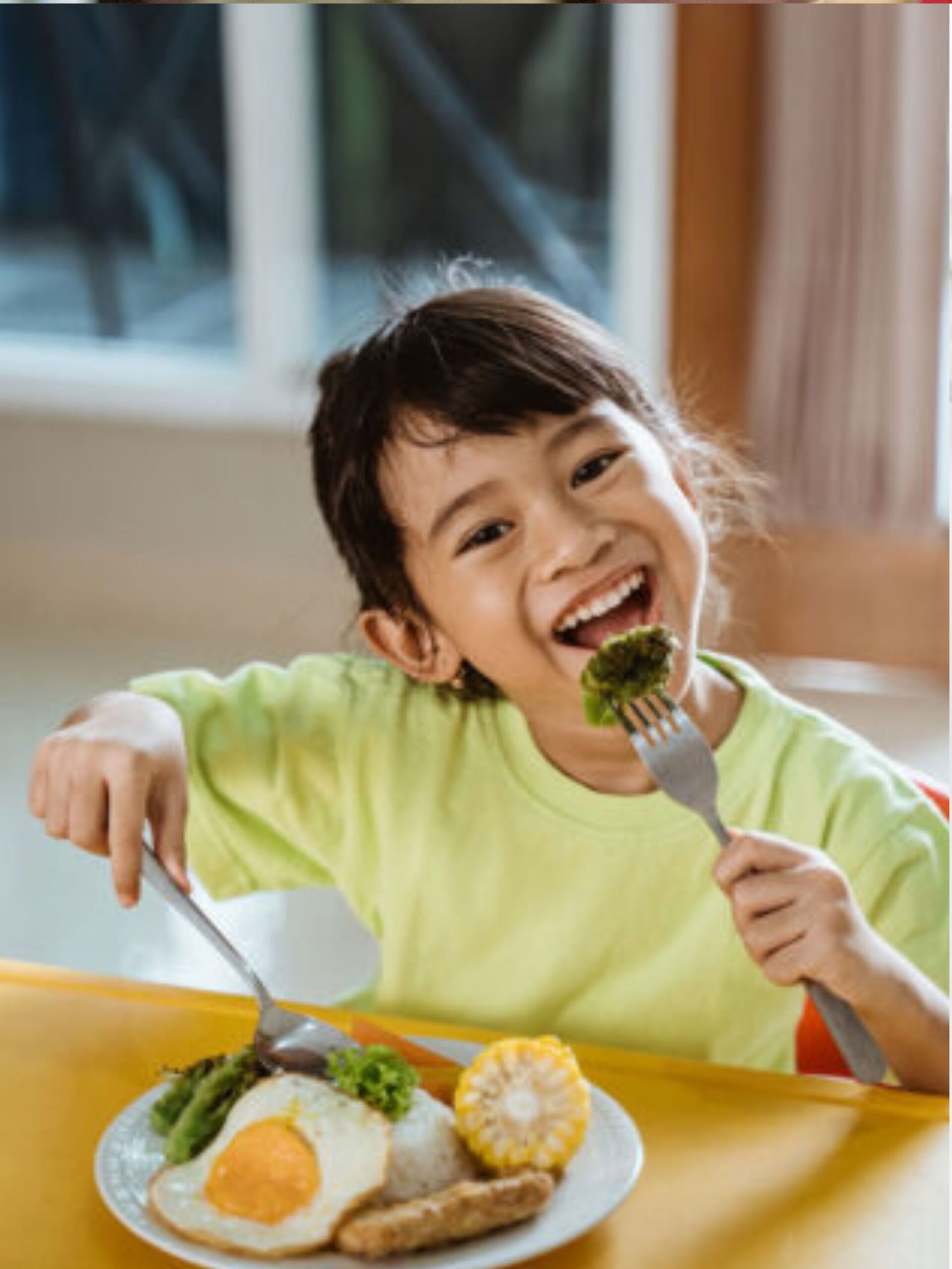 Cute kid eating a healthy breakfast